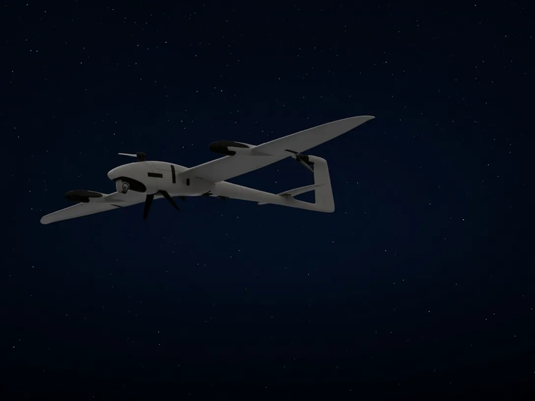 VTOL fixed-wing drone in flight against a night sky
